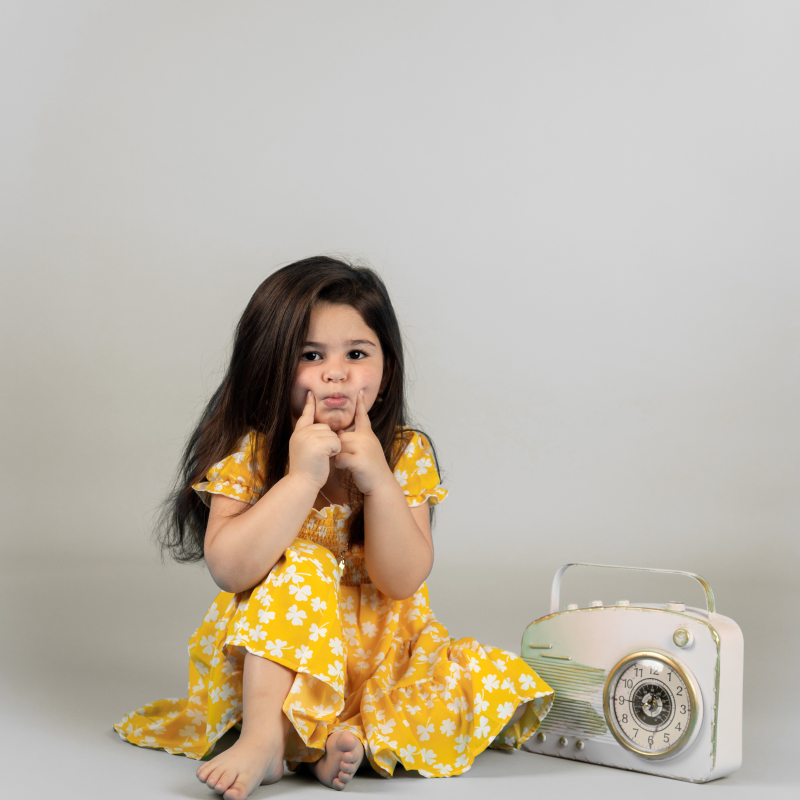 Happy kids posing during a creative outdoor photoshoot with colorful outfits and natural lighting